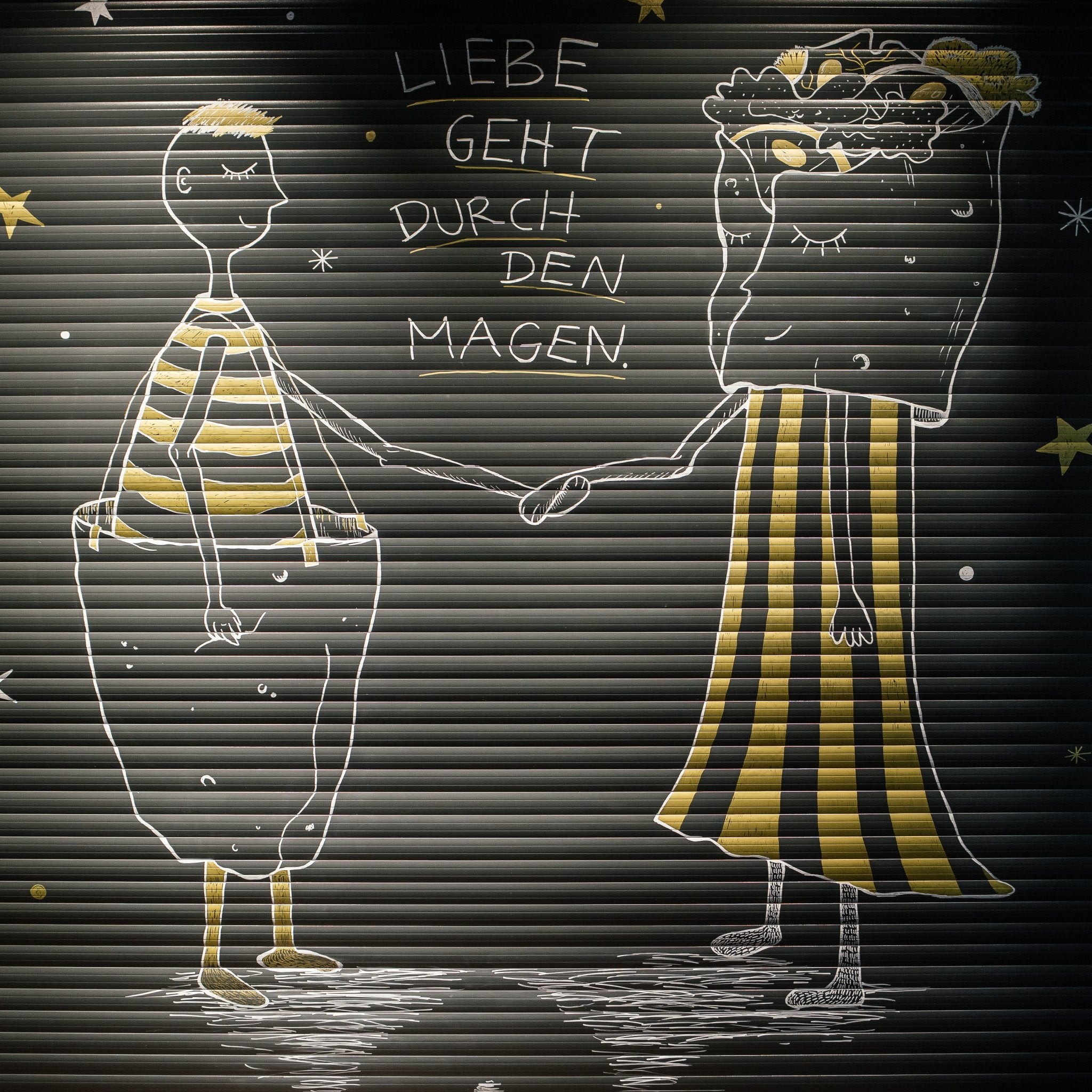 Wandgraffiti im Wrapstars Restaurant mit Illustration von Julia Auly und der Aufschrift: Liebe geht durch dem Magen.